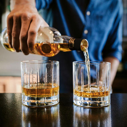 Individual Pouring a Drink in the Double Old-Fashioned Glass 