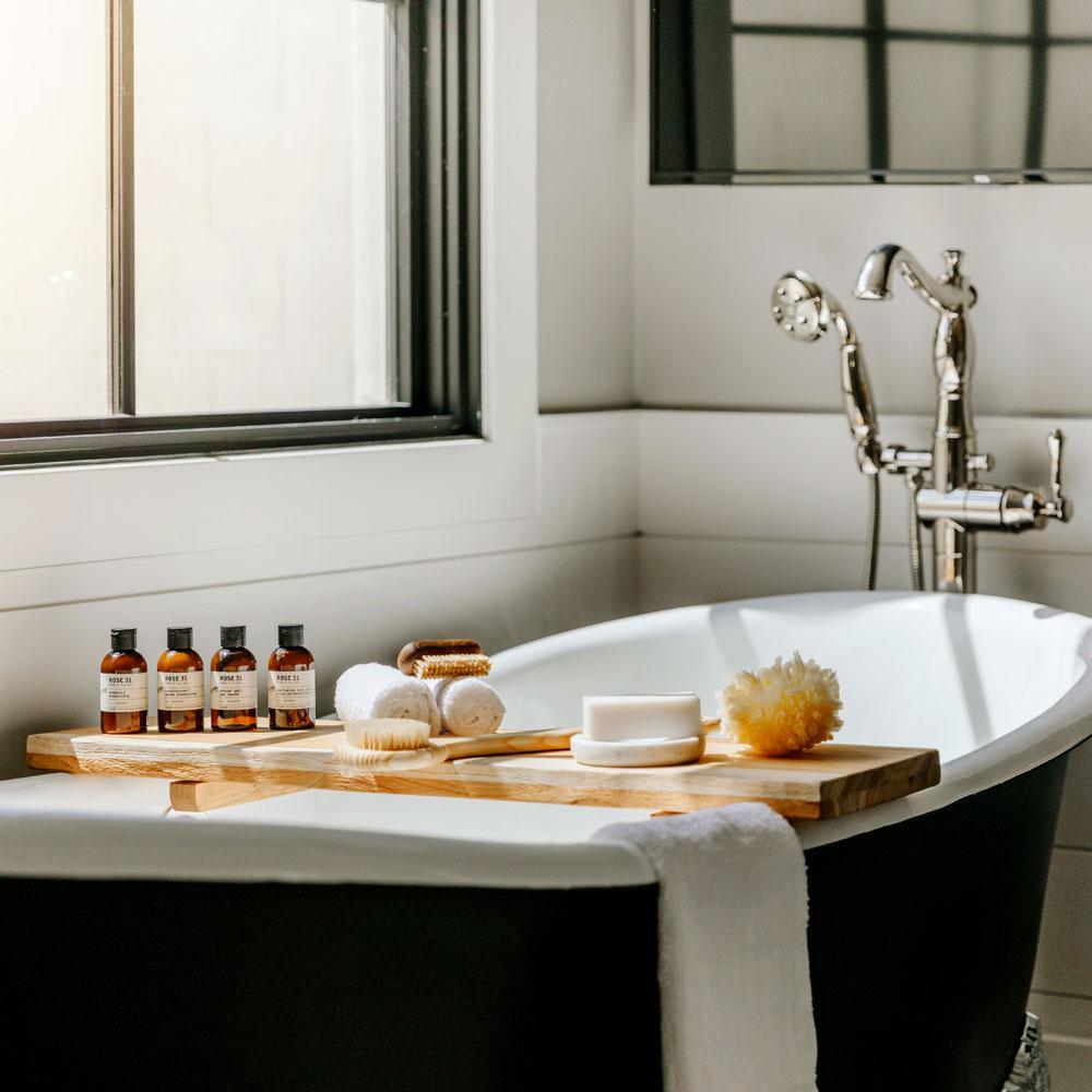 Le Labo Rose 31 collection on tray in bath tub