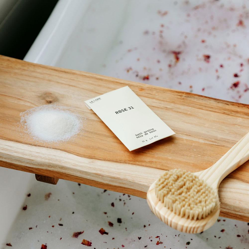 Le Labo Rose 31 Bath Salts on tray in bath tub