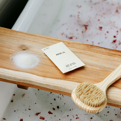 Le Labo Rose 31 Bath Salts on tray in bath tub